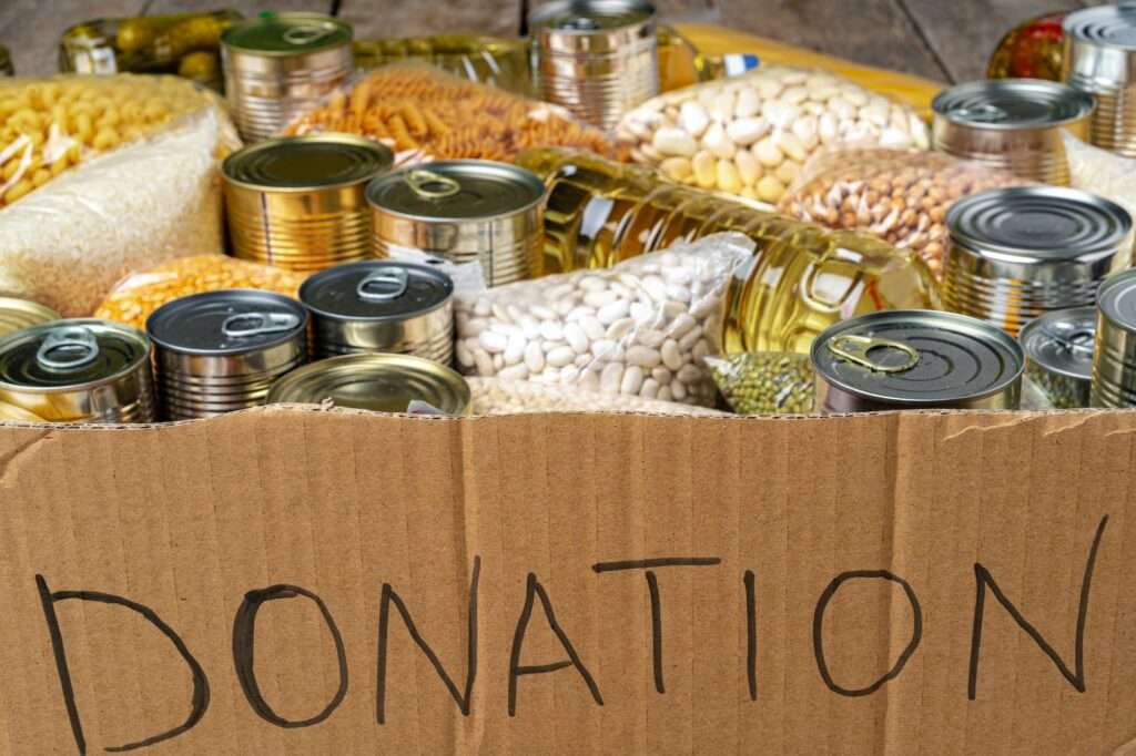 Food donations on the table. Text Donation